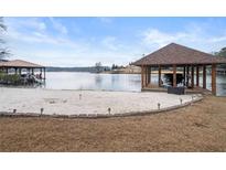 Beautiful lakefront property with a private beach, covered boat dock, and a lakeside cabana at 3167 Bay View Dr, Jonesboro, GA 30236