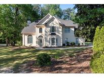 Charming traditional home with manicured front lawn and lush landscaping at 120 Julia Ct, Fayetteville, GA 30214