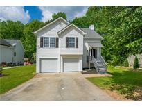 Charming two-story home with a two-car garage and a well-manicured front yard at 5135 Gable Ridge Way, Sugar Hill, GA 30518