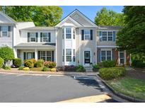 Charming townhome with manicured landscaping, black shutters, and convenient parking at 1575 Kilmington Ct, Alpharetta, GA 30009