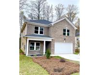 Charming two-story brick home featuring a covered porch, two-car garage, and a well-manicured front yard at 3357 Bonnes Ct, Ellenwood, GA 30294
