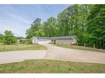 Charming ranch-style home with stone accents, attached garage, and a large front yard at 3349 Old Atlanta Rd, Suwanee, GA 30024