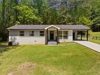 Charming single-story home featuring a carport and well-maintained front yard with ample green space at 2340 Cresta Dr, Decatur, GA 30032
