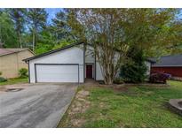 Charming single-Gathering home featuring a well-maintained lawn and a two-car garage at 1287 Peninsula Trce, Lawrenceville, GA 30044