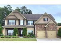Charming two-story home boasts a stone-accented facade and a well-manicured front yard at 2022 Boxwood Ln, Canton, GA 30114