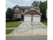 Charming two-story home featuring a brick facade and a two-car garage at 216 Diamond Valley Pass, Canton, GA 30114