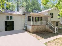 Charming home featuring a covered porch, a driveway and a neutral exterior paint at 488 Russell Rd, Lawrenceville, GA 30043