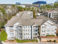 Inviting condo complex with multiple balconies, lush landscaping, and views of surrounding community buildings at 1250 Parkwood Se Cir # 300, Atlanta, GA 30339