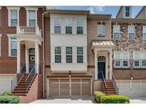 Charming townhome with brick facade, front-entry garage, and inviting entry staircase at 4905 Greylock Se Walk, Atlanta, GA 30339