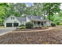 Charming two-story home with a brick walkway and well-maintained landscaping at 2130 Monticello Pl, Lawrenceville, GA 30043