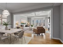 Bright living room with hardwood floors, neutral paint, a fireplace, and large windows at 850 Piedmont Ne Ave # 2509, Atlanta, GA 30308