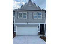 Charming townhome with gray siding, gray shutters, and a two-car garage at 6424 Rosetta Dr, South Fulton, GA 30331
