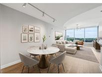 Bright living and dining room featuring a neutral palette, floor-to-ceiling windows, and stylish decor at 3338 Peachtree Rd # 1210, Atlanta, GA 30326