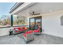 Relaxing outdoor patio with comfortable seating, ceiling fan, and view of surrounding trees at 337 Pine Ne St # B, Atlanta, GA 30308