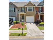 Charming townhome with manicured landscaping, attached garage, and neutral brick and siding at 3366 Thornbridge Dr, Powder Springs, GA 30127
