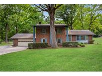 Charming brick two-story home with mature tree and large front yard at 1055 Heather Ct, Lawrenceville, GA 30043