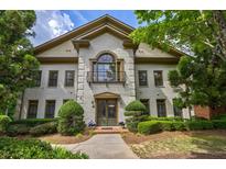 Elegant two-story home with a painted brick facade, balcony, and mature landscaping at 3127 Lenox Ne Rd # 1, Atlanta, GA 30324