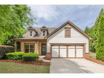 Charming home featuring a two-car garage, manicured lawn, and inviting craftsman architecture at 1355 Hesse Ln, Austell, GA 30106