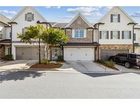 Charming townhome featuring a two-car garage and well-manicured landscaping in a desirable community at 565 Stone Field Nw Run, Marietta, GA 30060