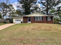 Charming single-story home with brick accents, attached garage, and a well-maintained lawn at 1685 Pheasant Dr, Jonesboro, GA 30238