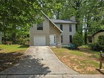 Charming two-story home with a one-car garage and front lawn at 3948 Valley Brook Rd, Snellville, GA 30039