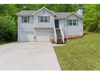 Charming home with a two-car garage and well-maintained lawn at 401 Farm Brook Ln, Dallas, GA 30157