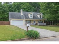 Charming traditional home with a welcoming front porch and a well-maintained lawn at 420 Bear Cub Path, Social Circle, GA 30025