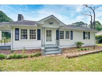 Charming home featuring a white exterior, inviting front porch, and a well-maintained front yard at 1236 Stone Mountain Lithonia Rd, Lithonia, GA 30058