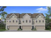 Charming exterior elevation of a new construction townhome featuring a two-car garage and professionally landscaped front yard at 190 Abbotts Crossing Cir, Conyers, GA 30094
