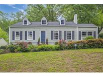 Charming home featuring a landscaped front yard and classic architectural details at 1861 Ardmore Nw Rd, Atlanta, GA 30309