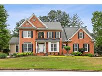 Charming two-story brick home featuring manicured landscaping and a welcoming front entrance at 205 Devon Downs Pl, Alpharetta, GA 30005