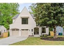 Charming two-story home features a white brick facade, arched entryway, and a two-car garage at 3006 Skyland Ne Dr, Brookhaven, GA 30319