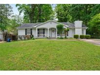 Charming single-story home with a lush green lawn and a welcoming front porch at 34 Duke Dr, Lawrenceville, GA 30046