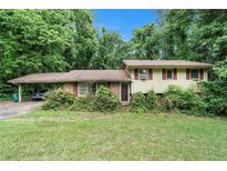 Charming single Gathering home with a nice front yard surrounded by mature trees at 2214 River Rd, Ellenwood, GA 30294