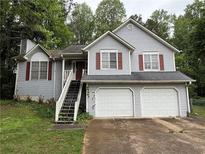Charming two-story home features a two car garage and gray siding at 2326 Westland Way, Acworth, GA 30102