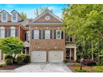 Charming brick home with a two-car garage and manicured landscaping at 5407 Waters Edge Trl, Roswell, GA 30075