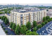 Attractive condominium building with a view of the Atlanta skyline surrounded by mature trees at 711 Cosmopolitan Ne Dr # 123, Atlanta, GA 30324