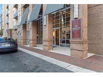 Brick facade and glass entrance to the 711 Cosmopolitan Buckhead building in Atlanta at 711 Cosmopolitan Ne Dr # 123, Atlanta, GA 30324
