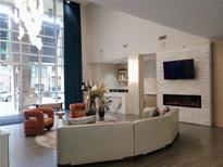 Bright lobby area featuring a fireplace, comfortable seating, and large windows at 711 Cosmopolitan Ne Dr # 123, Atlanta, GA 30324