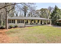 Charming single-story home with a welcoming front porch and well-maintained lawn at 1598 Kings Rd, Marietta, GA 30062