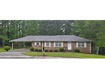 Charming one-story brick home with a covered carport and a well-manicured front lawn at 2555 Angus Sw Ct, Marietta, GA 30008