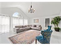 Bright living room with vaulted ceiling, large windows, and modern decor at 101 Saddlehorn Ct, Woodstock, GA 30188