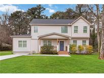 Charming two-story home with a well-manicured lawn, inviting porch, and a mix of painted brick and siding at 2206 Loring Ct, Decatur, GA 30032