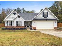 Charming single-story home features a well-manicured lawn and an attached two-car garage at 20 Madison Ct, Covington, GA 30016