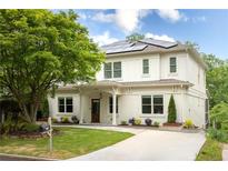 Beautiful two-story home with solar panels, a well-manicured lawn, and mature landscaping at 331 Gordon Ne Ave, Atlanta, GA 30307