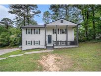 Charming two-story home with a covered front porch, and traditional landscaping at 6547 Demere Dr, Morrow, GA 30260
