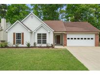 Charming single-story home featuring a well-manicured lawn and a two-car garage at 1095 Athena Ct, Acworth, GA 30101