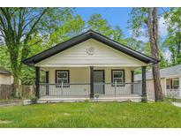 Charming bungalow featuring a cozy front porch and manicured lawn at 1477 Olive Sw St, Atlanta, GA 30310