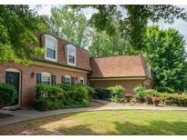 Traditional brick home featuring a well-maintained lawn, mature trees, and classic architectural details at 1261 Lavista Rd # N4, Atlanta, GA 30324