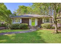 Charming home with cedar shake siding, manicured lawn, and a bright green front door at 2049 Oakview Se Rd, Atlanta, GA 30317